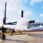 Refinery Terminal Fire Company - Exterior - Men Working with Hoses
